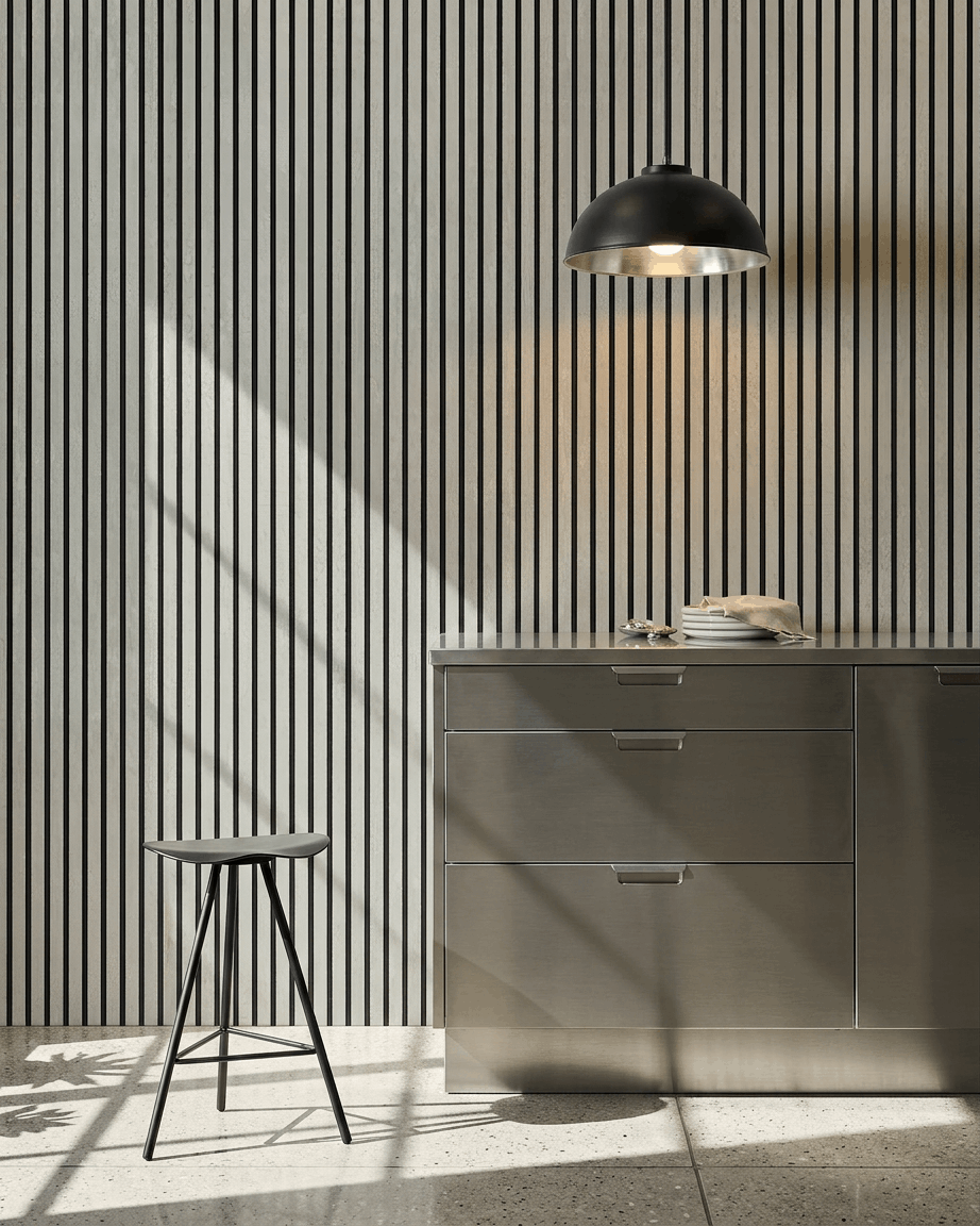 Minimalist kitchen featuring a WoodUpp Akupanel acoustic panel in Oxide White with Black Felt, 240x60 cm, as a vertical slatted wall feature.