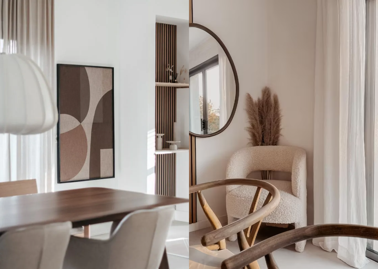 Minimalist Nordic living space with neutral tones, Akupanel acoustic wood panel as wall art, round mirror, beige accent chair, wooden dining table, and pampas grass centerpiece.