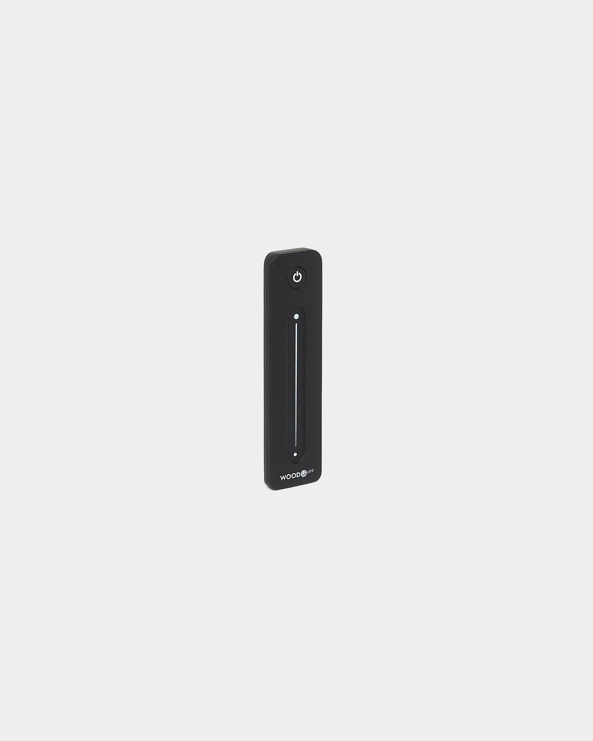 Slim black WoodUpp Lumi Remote for LED striplights, with vertical touch slider and power button, Philips Hue compatible, shown on a white background.