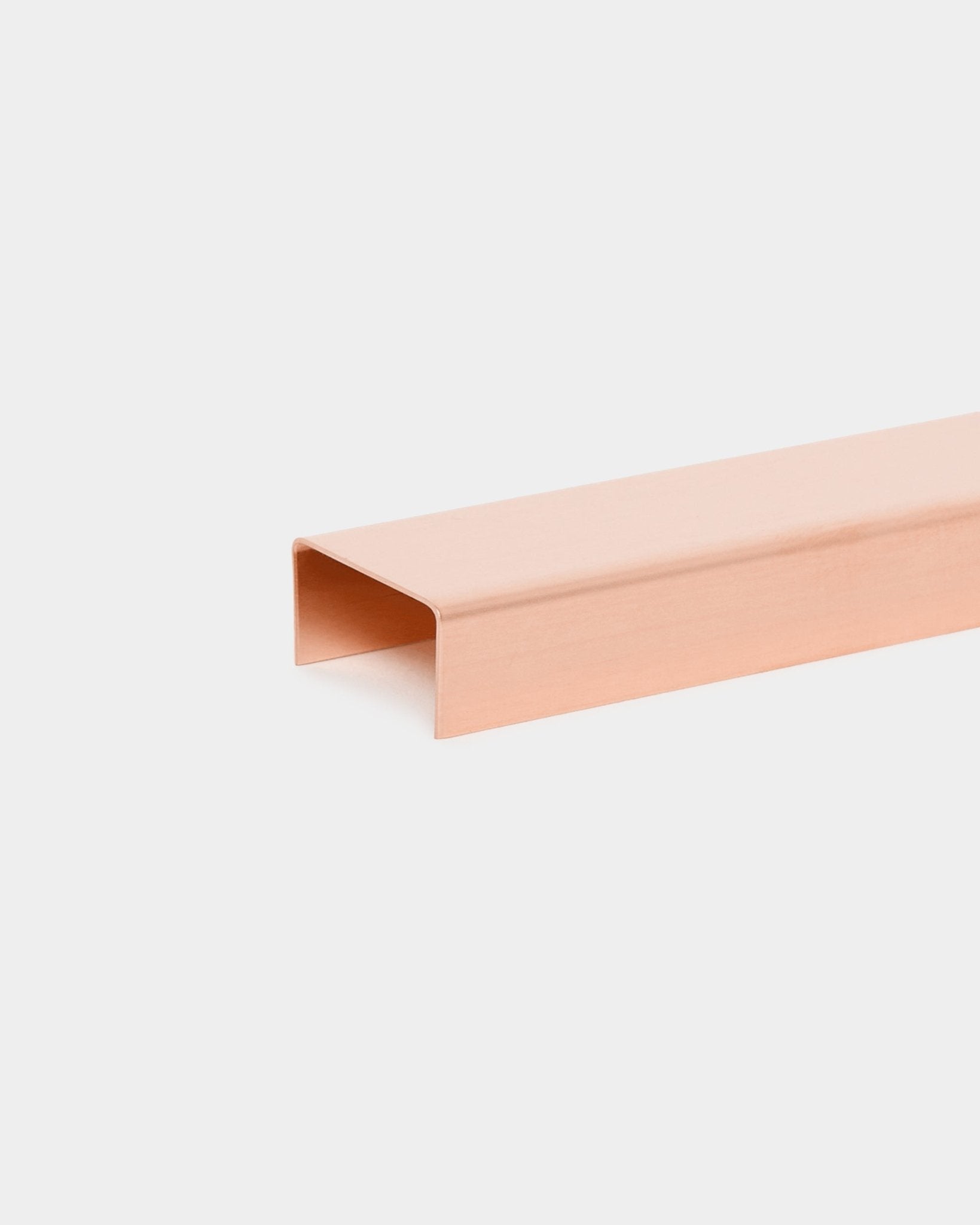 A rectangular copper channel with a U-shaped cross-section, displayed on a white background, shown as part of Nordic acoustic panel accessory components.