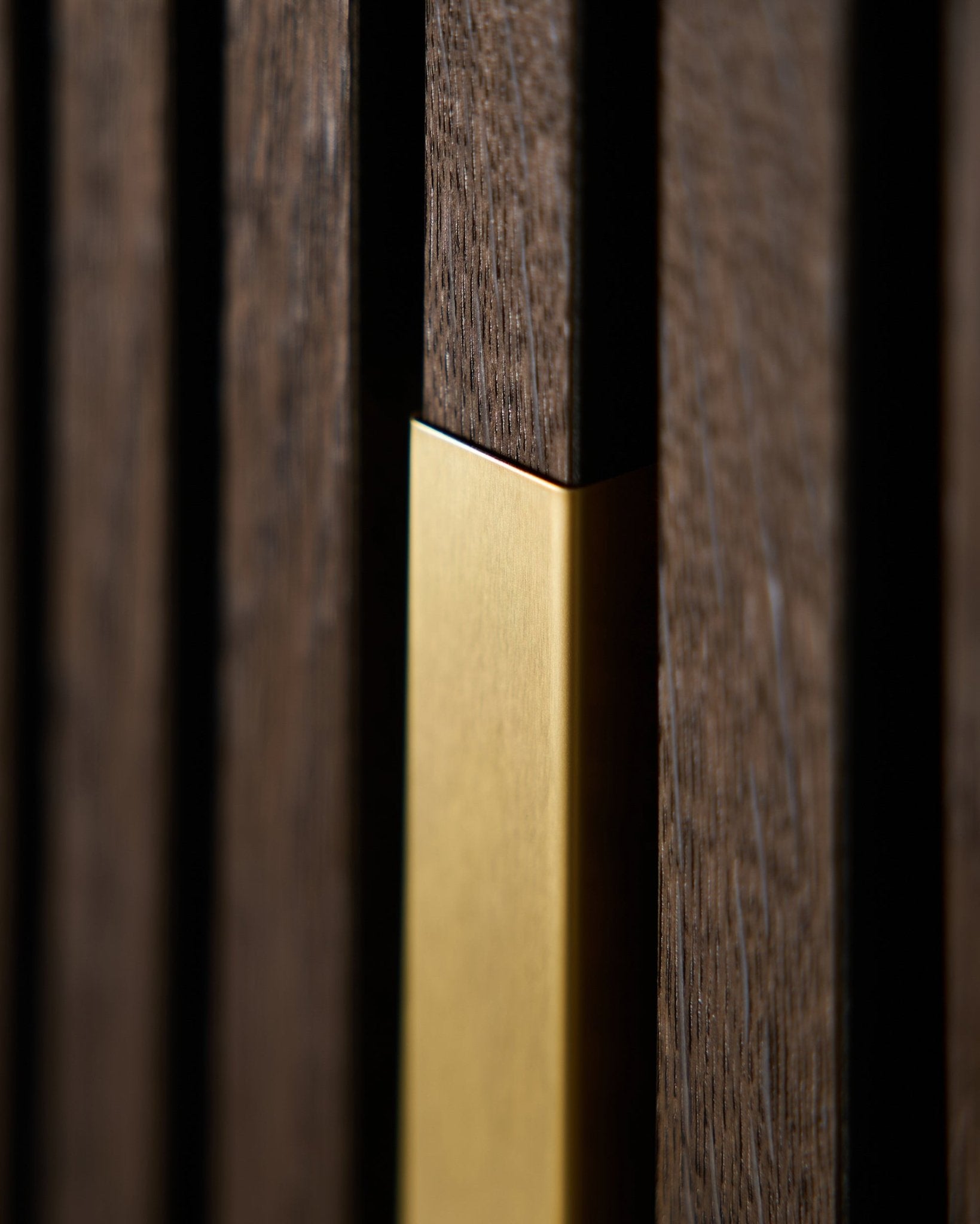 Close-up of WoodUpp Liva | Cover / Brass, 120 cm—a vertical acoustic panel with matte gold trim, designed for decorative wall applications.
