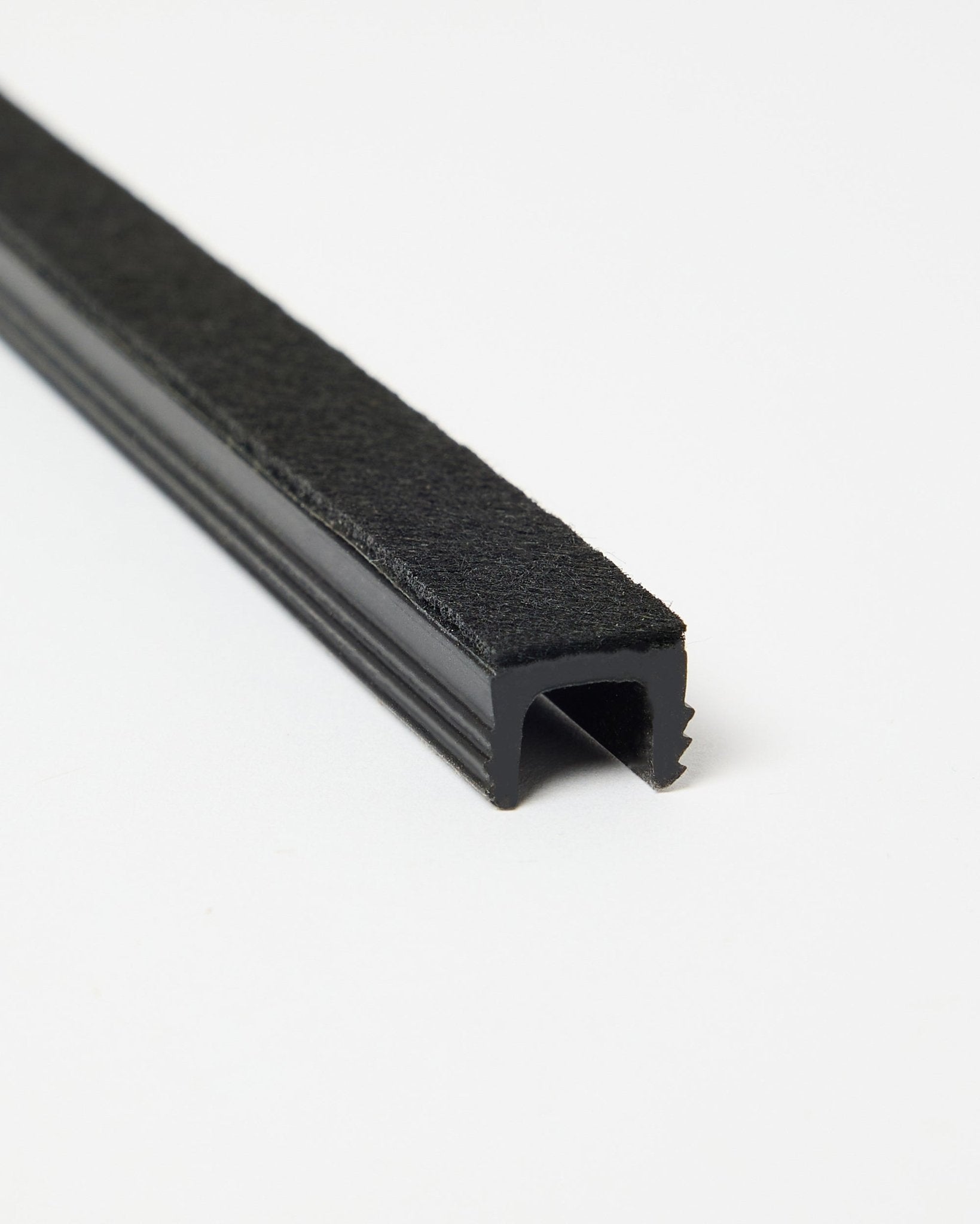 Three black Dupps Pop-on Cable Covers by WoodUpp, shown angled on a white background to display their form and finish. Accessories for Akupanel systems.