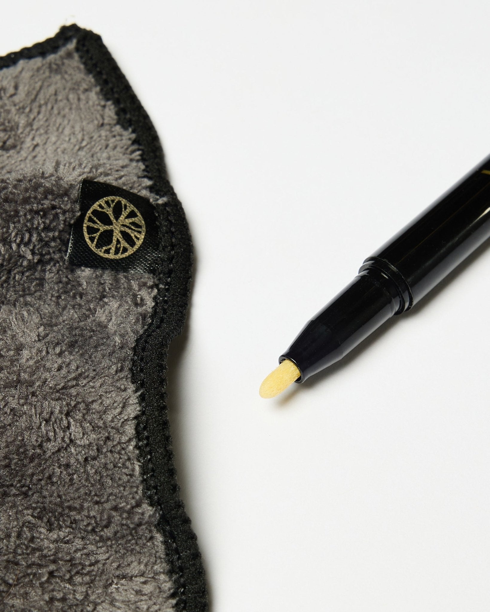 The Norr Blackboard set by WoodUpp includes a black chalk ink marker with yellow tip and a gray microfiber cloth with gold tag, shown on a white surface.
