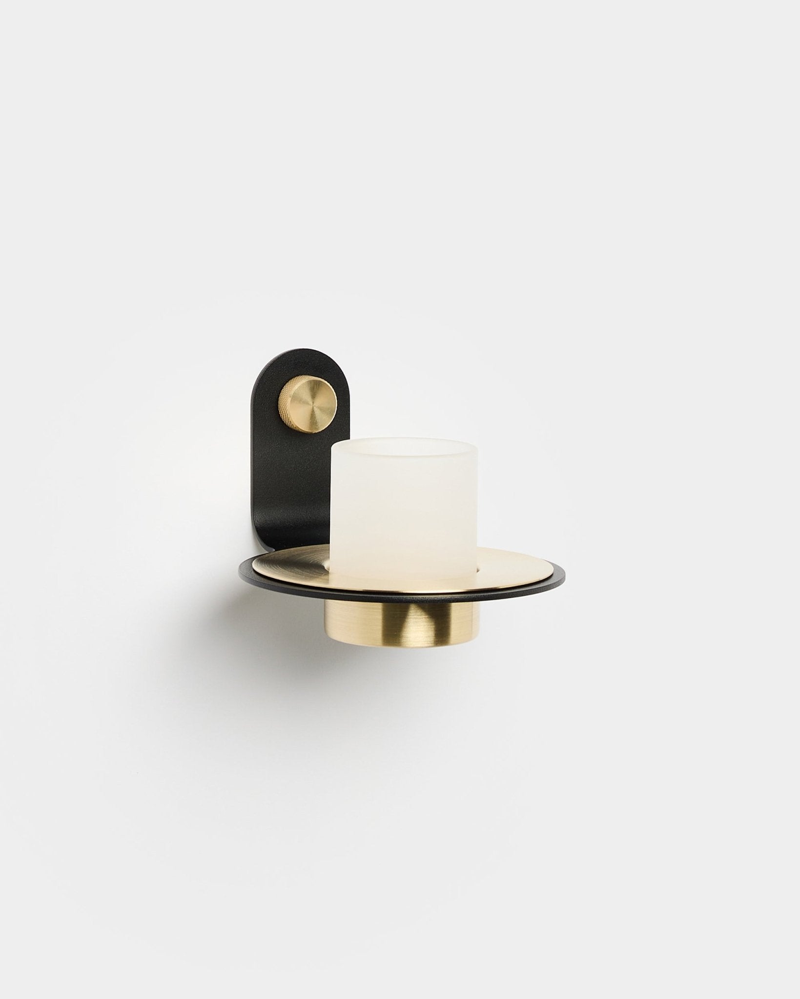 Norr Candle Holder by WoodUpp with a black and brass base and frosted glass shade, designed to complement LED candles; aligns with Nordic minimalist style.
