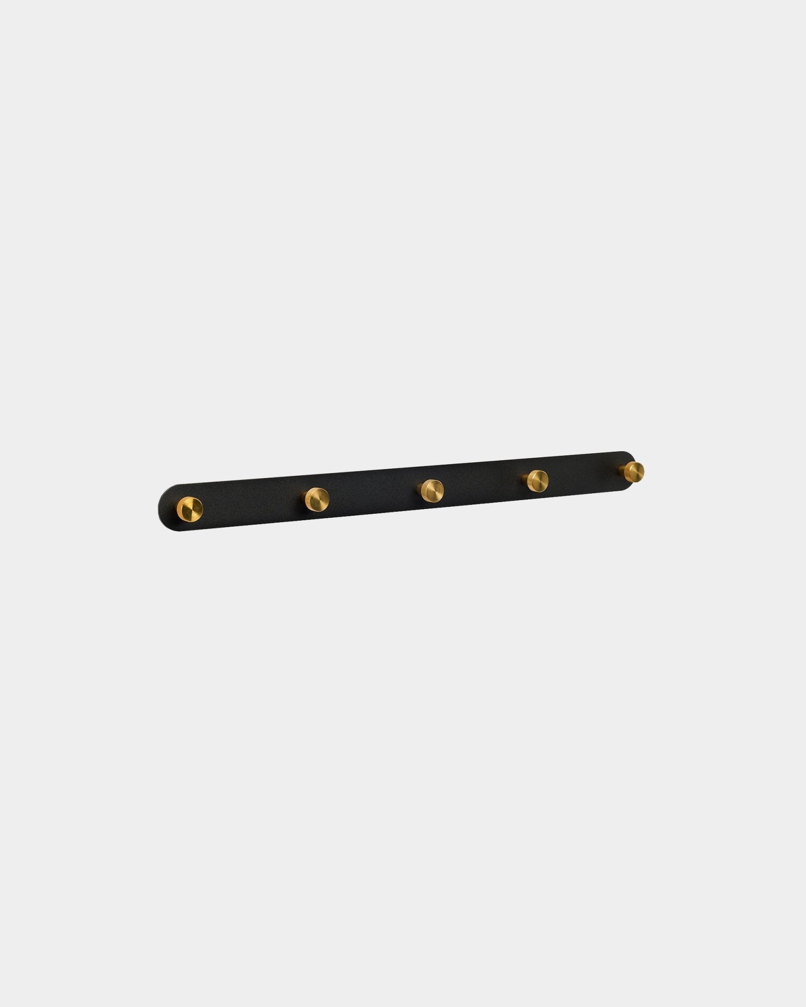 WoodUpp Norr coat hook rack in black and brass with 5 steel hooks, wall-mounted, displayed against a plain white background.