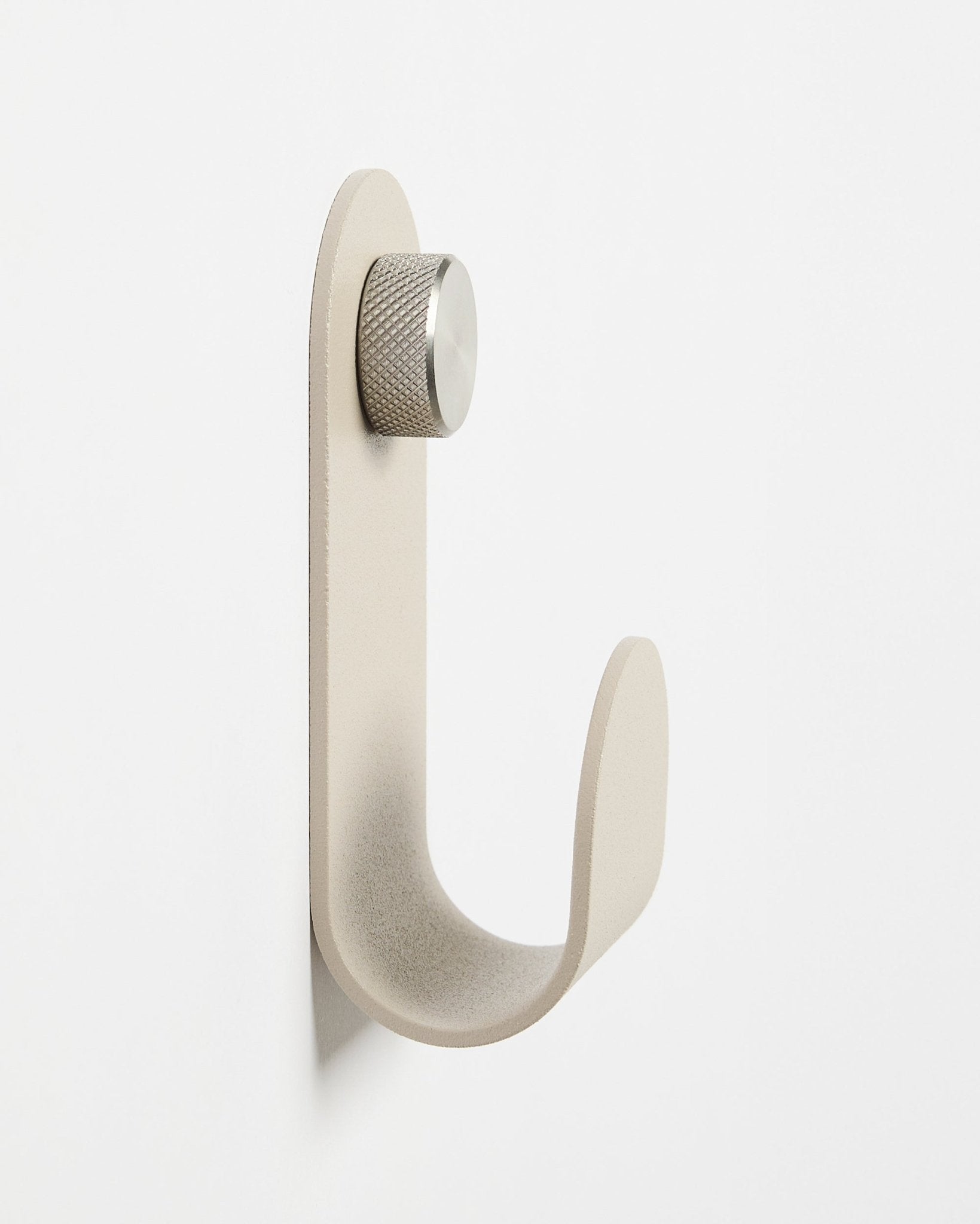 The Norr | Single Hanger in Beige by WoodUpp, a minimalist wall-mounted accessory with a silver knob, designed to complement Akupanel acoustic wood panels.