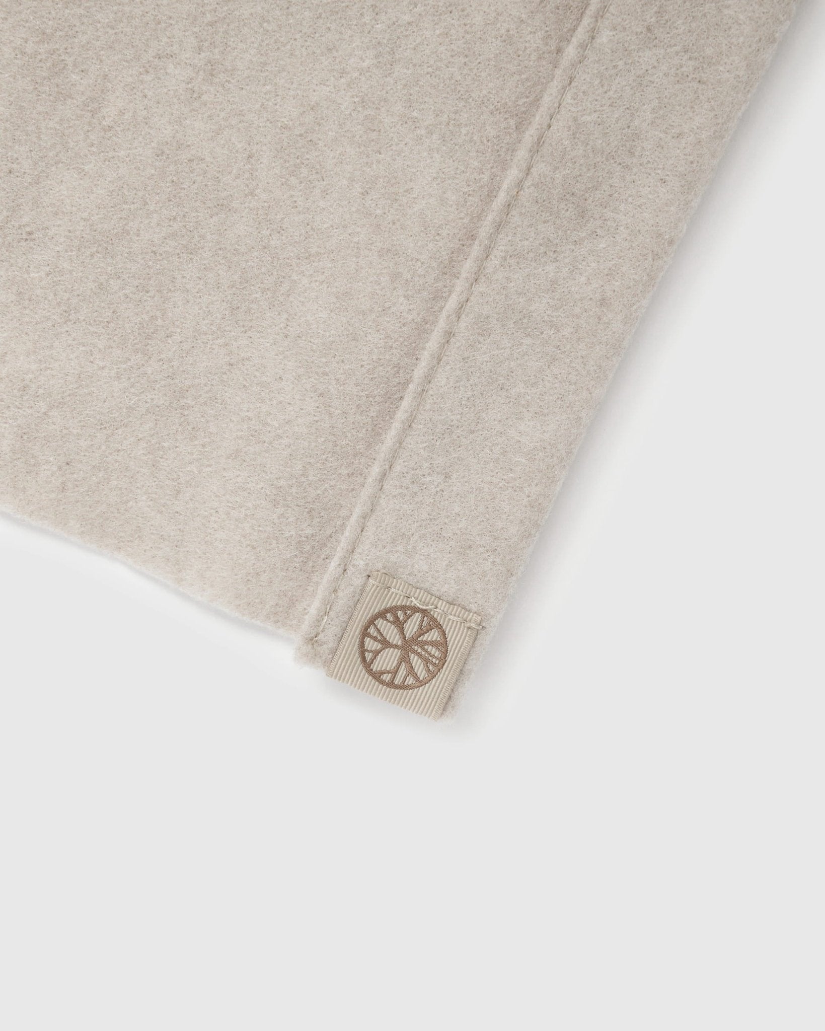 WoodUpp Vigg acoustic felt sheet, light beige (58x241cm), with stitched edge and geometric patch detail, displayed on a white background.