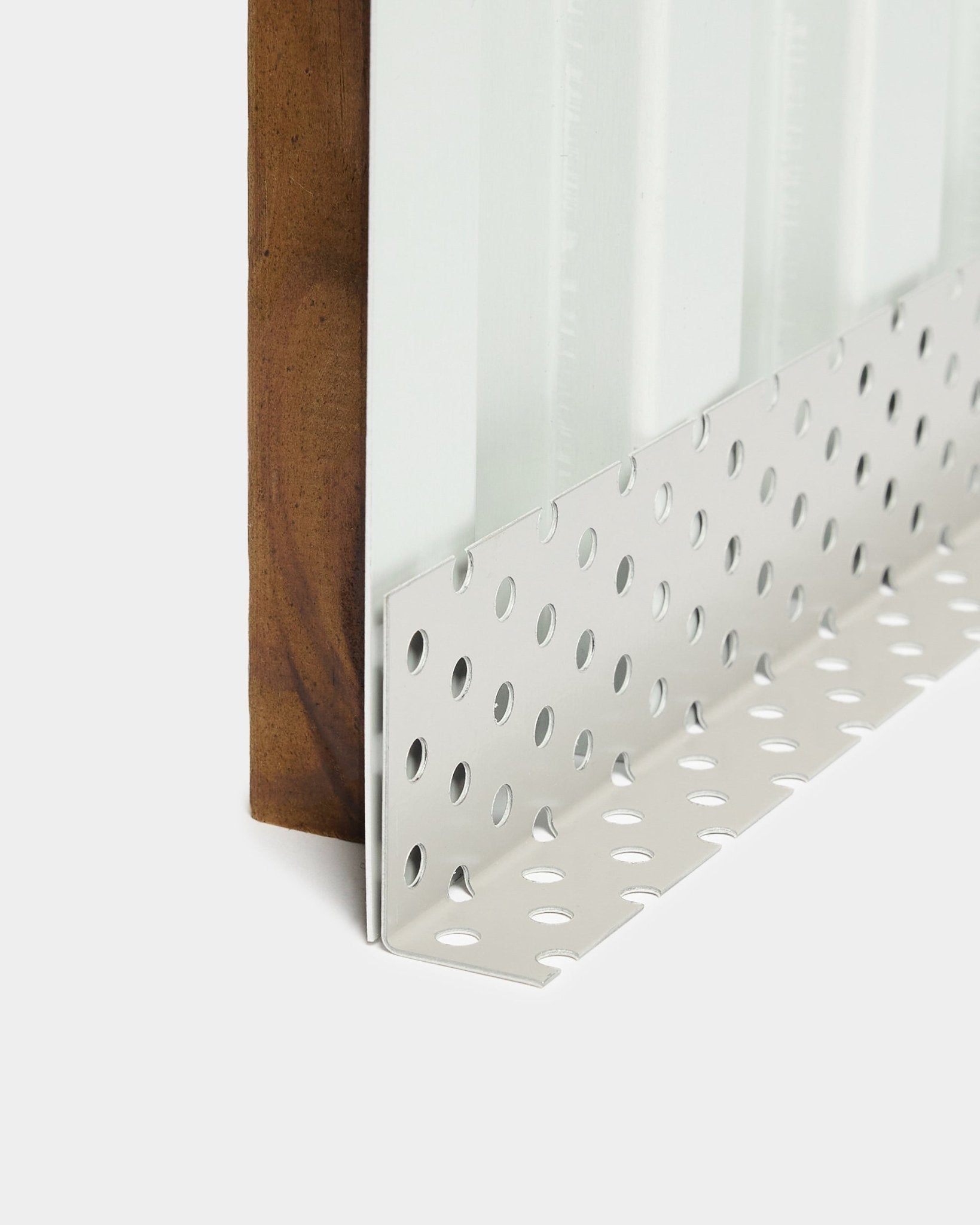 Close-up of Aluwood facade panel installation accessory: metal corner bead with large round perforations, designed for ventilated cavities, 240 cm length.