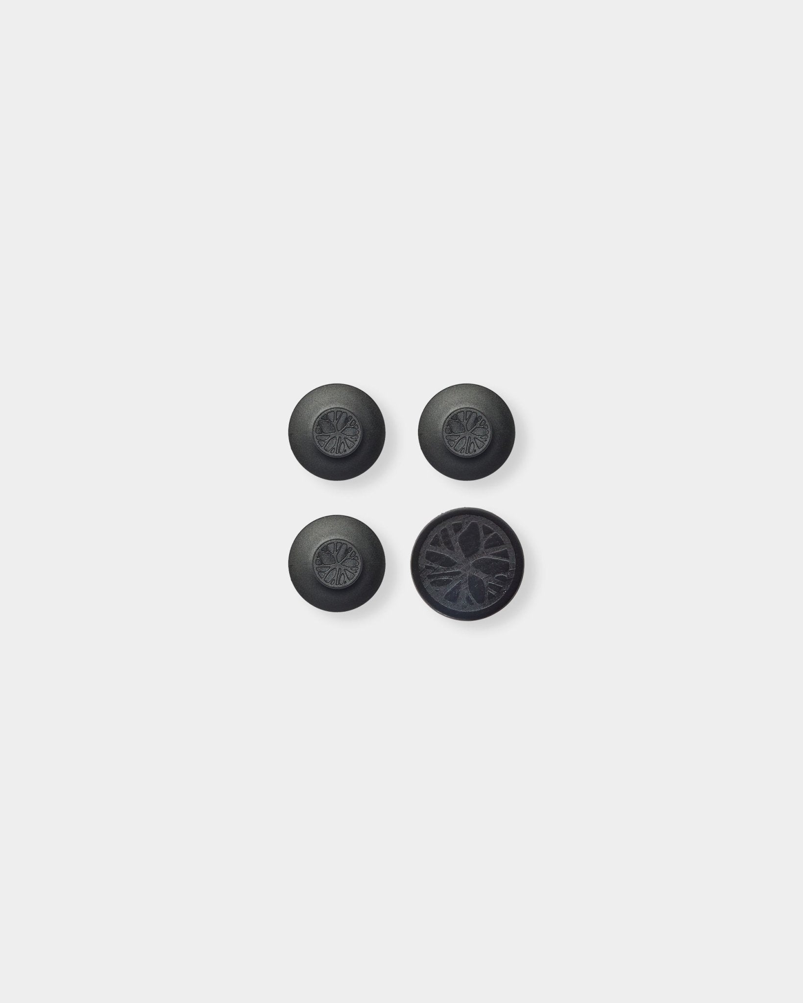 Three round black Dupps and one circular piece featuring a detailed Nordic WoodUpp Akupanel-inspired acoustic wood slat pattern on a light gray background.